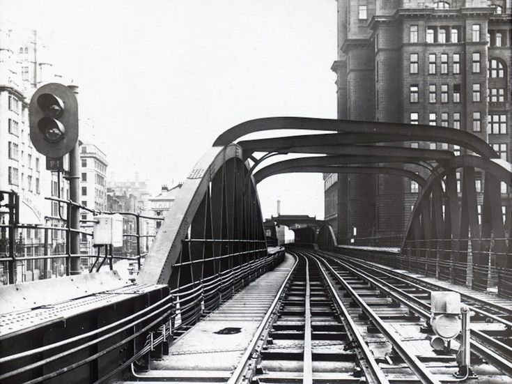 an old black and white photo of train tracks