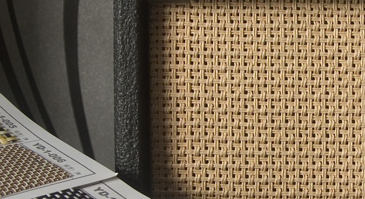 a stack of newspapers sitting on top of a table next to a chair with an upholstered seat