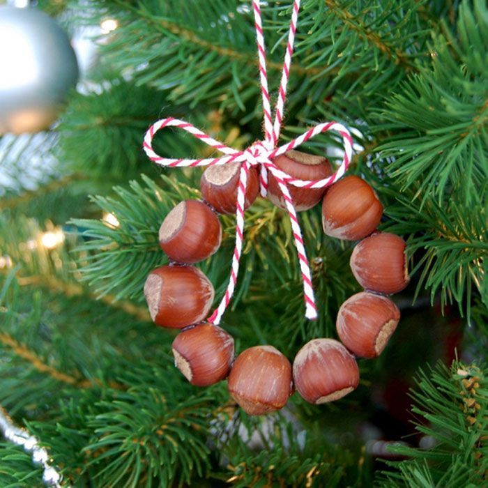 an ornament hanging from a christmas tree decorated with nuts and candy canes