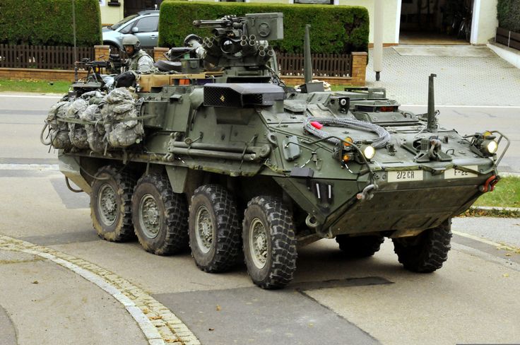 an army vehicle is parked on the street