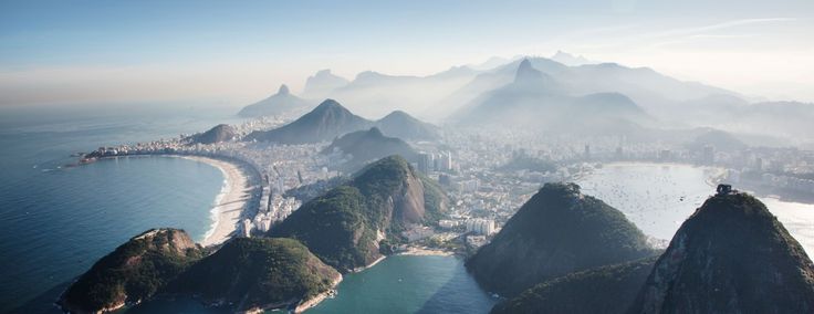 an aerial view of some mountains and the ocean