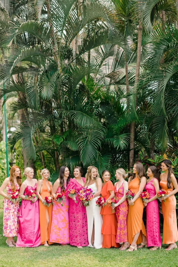 a group of women standing next to each other in dresses