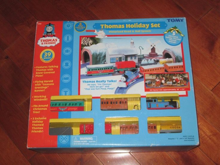 a thomas the tank train set in its box on a wooden floor with it's instructions