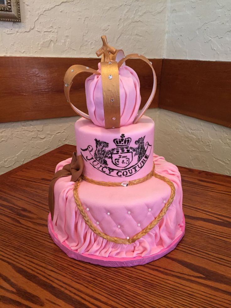 a pink and gold cake with a crown on top