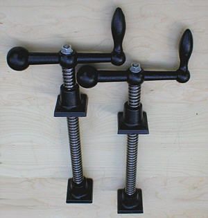 two black metal brackets with screws attached to them