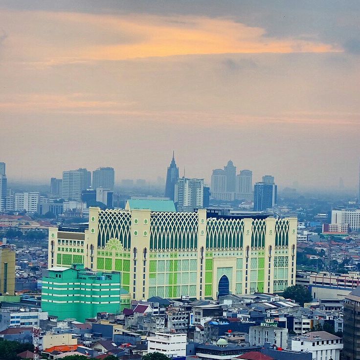 an aerial view of a city with tall buildings and skyscrapers in the back ground