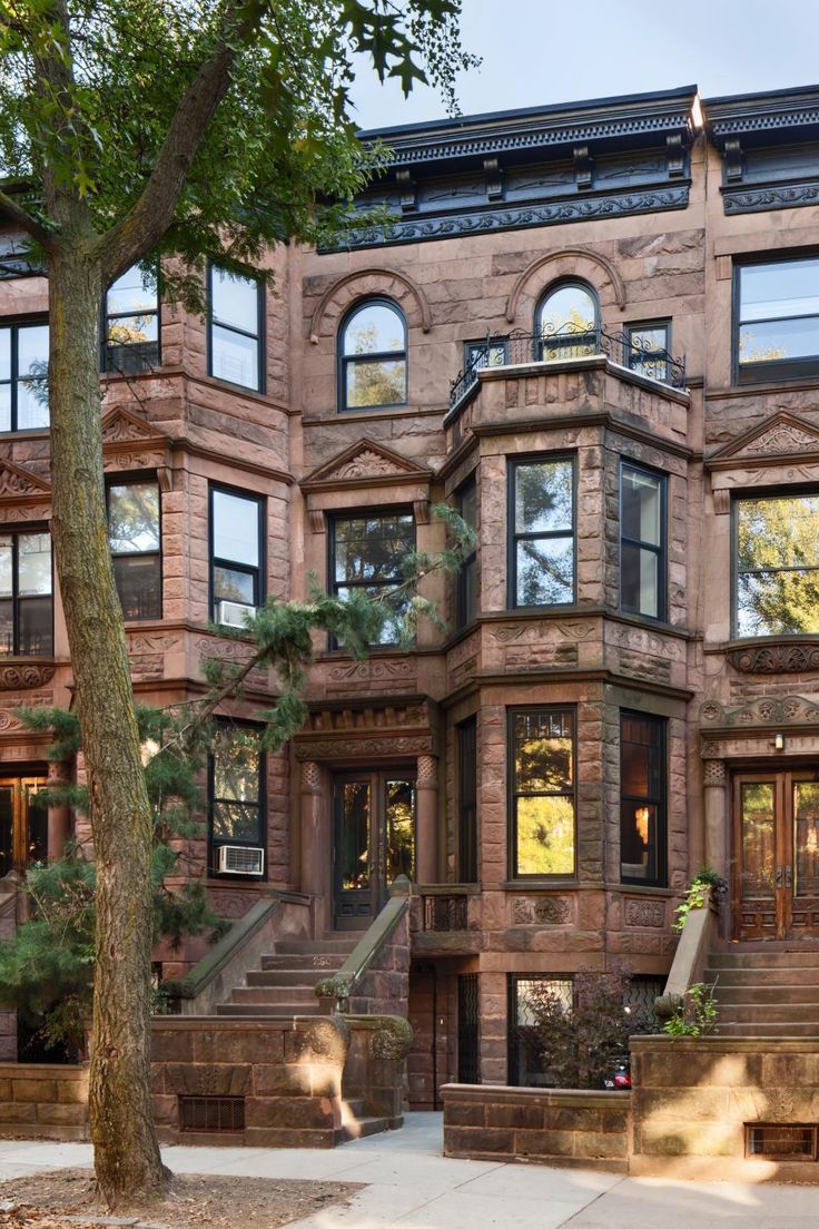 an apartment building with many windows and stairs