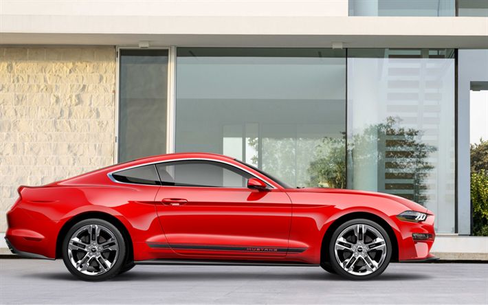 a red mustang parked in front of a building