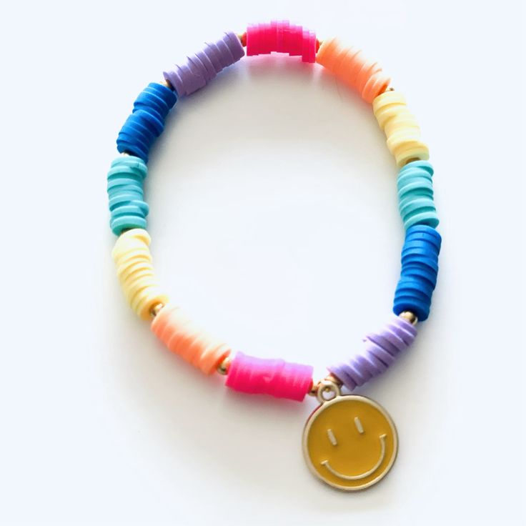 - Smiley Face is approx 1/2" diameter- Smiley Face is made of metal- Colorful beads are made of clay (feel almost like rubber)- Bracelets made on heavy duty elastic for easy on and off Cheap Everyday Smiley Face Jewelry, Red Smiley Face Clay Bracelet, Adjustable Rainbow Heart Beads Jewelry, Adjustable Rainbow Beaded Bracelets With Heart Beads, Adjustable Rainbow Heishi Beads Bracelet, Adjustable Rainbow Stretch Bracelet Hand-strung, Colorful Adjustable Letter Beads Jewelry, Adjustable Rainbow Hand-strung Stretch Bracelet, Rainbow Heishi Beads Friendship Bracelet