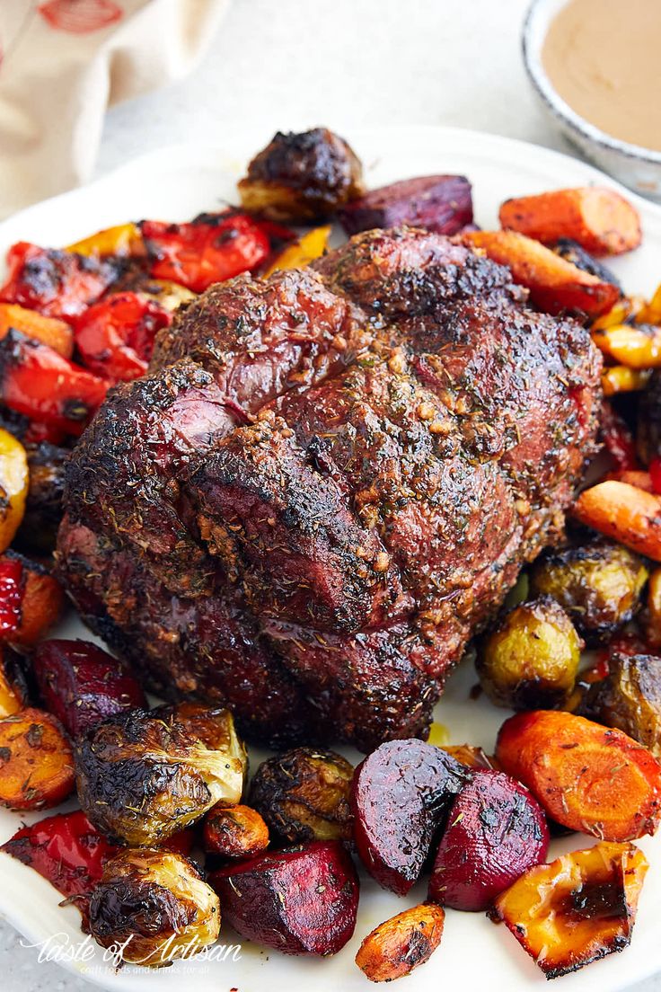 a white plate topped with meat and veggies