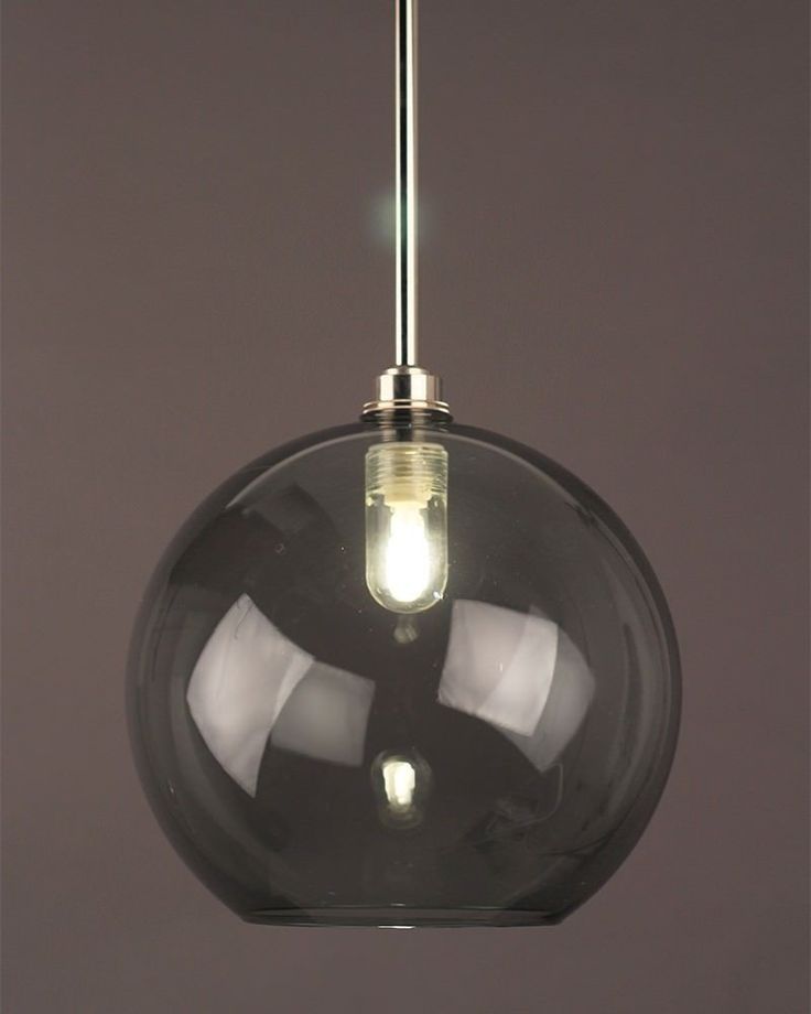 a glass light hanging from a ceiling fixture