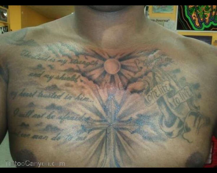 a man with tattoos on his chest is looking at the camera