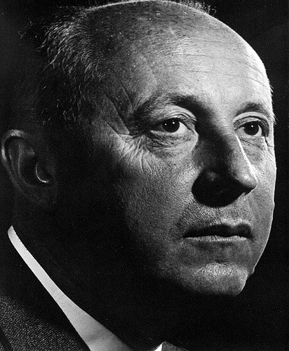 an old black and white photo of a man in a suit looking off to the side