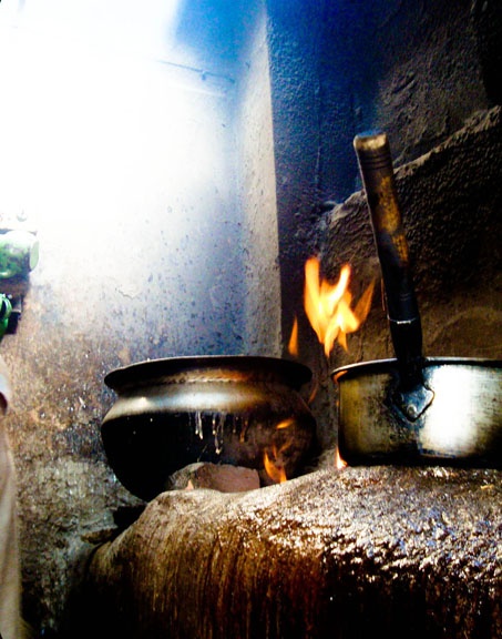 two pots on fire in an old kitchen