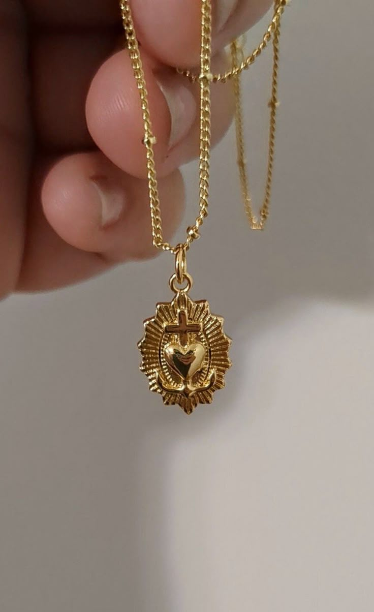 Discover elegance and spiritual grace with our 24k Gold-filled Dainty Sacred Heart Necklace. Delicately crafted and measuring 18 inches in length, this necklace features a beautifully detailed Sacred Heart pendant that symbolizes love, devotion, and protection. The intricate design and high-quality materials make it a perfect piece for everyday wear or special occasions, adding a touch of timeless beauty to any outfit. Treat yourself or a loved one to this exquisite blend of faith and fashion, m Vintage Gold Plated Heart Necklace, Gold Spiritual Heart Necklace, Ornate Gold Heart Pendant Jewelry, Sacred Heart Pendant, Sacred Heart Necklace Gold, Gold Heart-shaped Spiritual Necklace, Sacred Heart Pendant Gold, Sacred Heart Necklace, Vintage Gold Necklace