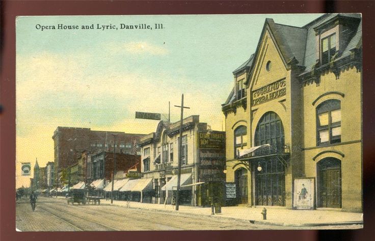 an old postcard shows people walking on the street in front of buildings and shops