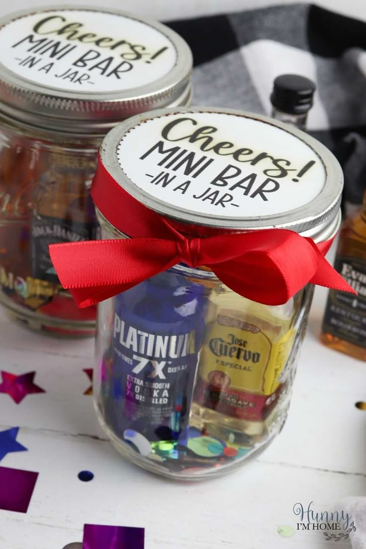 three mason jars with labels on them and some confetti in the bottom one has a red bow