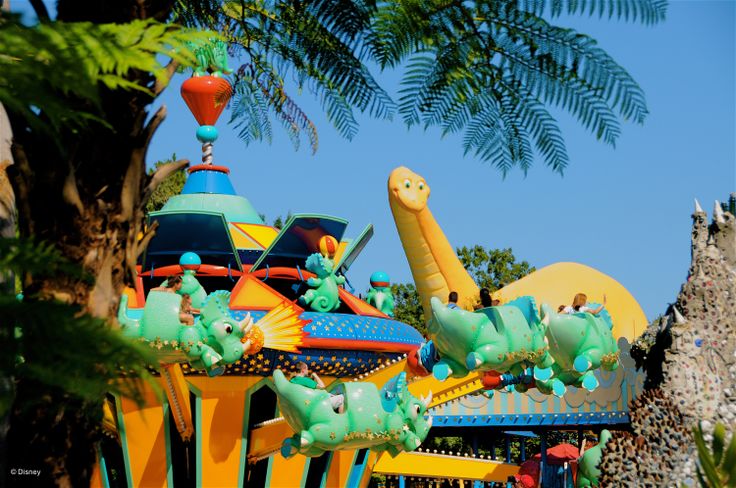 an amusement park ride with dinosaurs on it