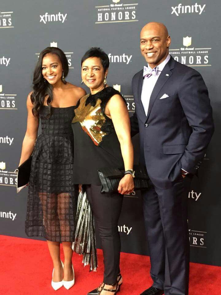 two women and a man are standing on the red carpet at an awards event together