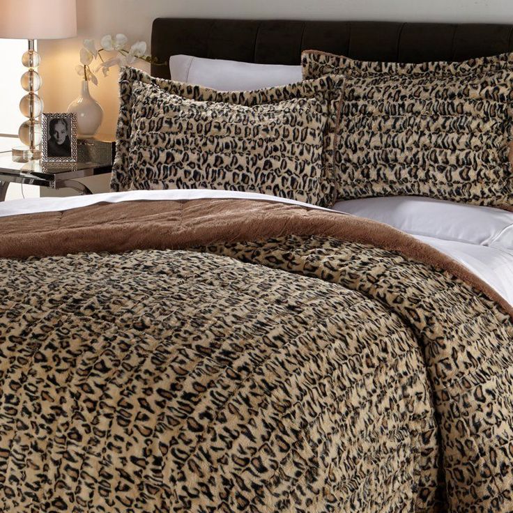 a leopard print comforter set on a bed