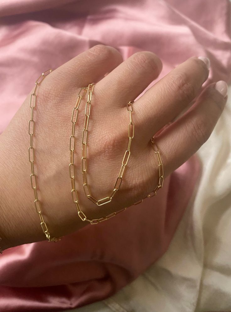 This Solid 14k Paper Clip gold Bracelet looks great when worn by itself or with your favorite charms. It's a Basic Piece of Jewelry that everyone must have in their jewelry collection. Available: In 14k Yellow, White, and Pink Gold Chain style: Paper Clip Link Size: 5x3 mm Lock: Lobster Claw Length: 61/2 to 7 inches Made In New York Available: In different lengths please select options Made to Order: Please allow 5-10 days to process your order 14k Gold Rectangular Paperclip Chain Bracelet, 14k Gold Oval Link Box Chain Jewelry, 14k Gold Filled Box Chain Link Jewelry, Classic Sterling Silver Gold Bracelet, Gold Chain Bracelet 14k Gift, Gold Chain Bracelet 14k As Gift, Dainty 14k Gold Paperclip Chain Jewelry, 14k Gold Chain Bracelet As Gift, 14k Gold Chain Bracelet For Everyday Luxury