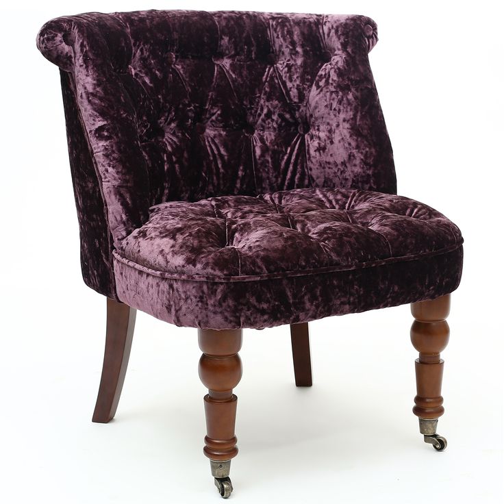 a purple velvet chair with wooden legs and casteors on an isolated white background,