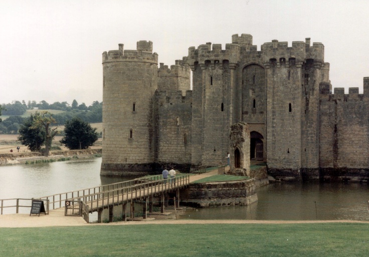 an old photo of a castle next to a body of water