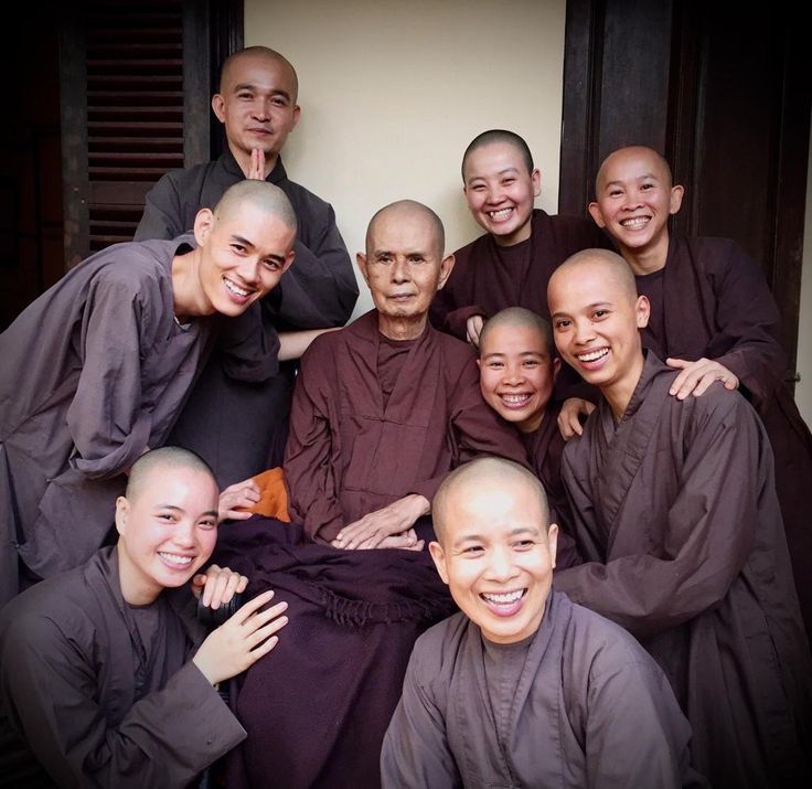 a group of monks pose for a photo together