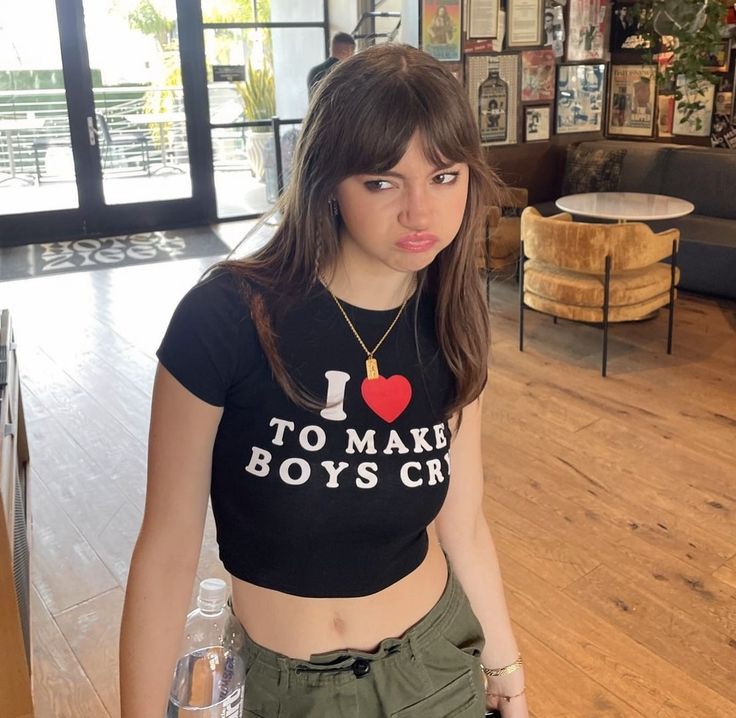 a girl in a t - shirt that says i love to make boys cry