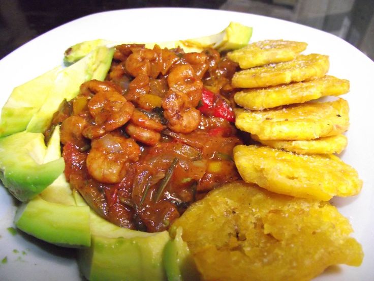 a white plate topped with bananas and other foods