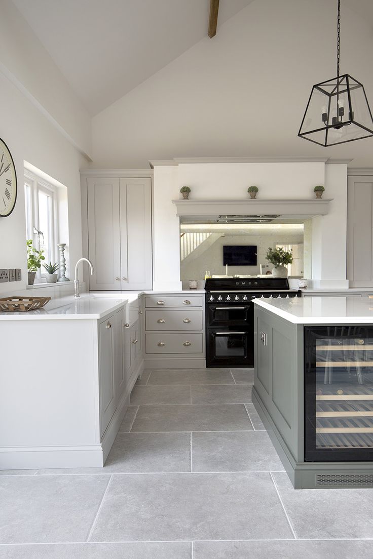 a kitchen with an oven, refrigerator and sink in it's center island area