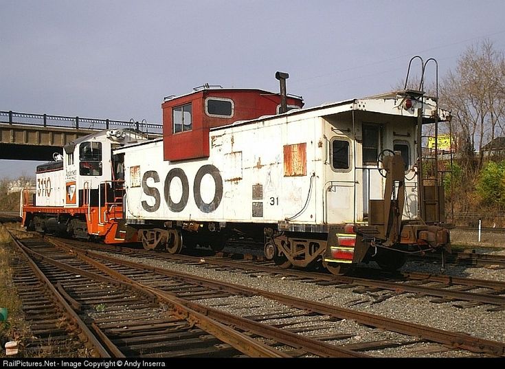 an old train car sitting on the tracks