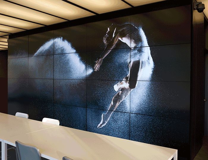 an office with a large wall mural depicting a man doing acrobatic tricks