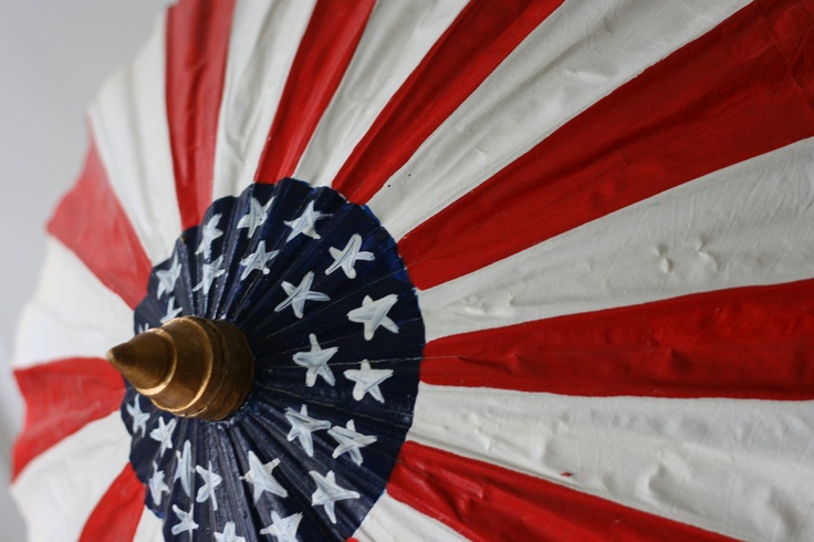 an american flag umbrella is hanging on the wall