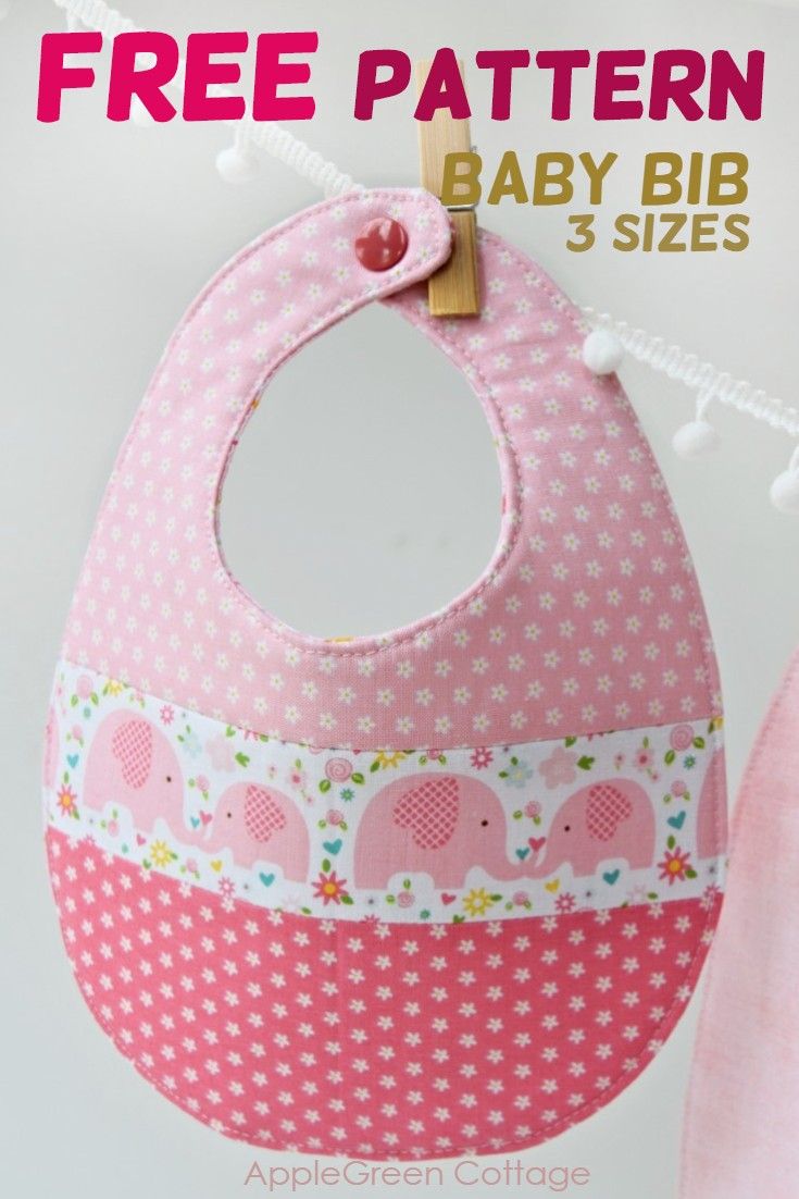 a pink bib with an elephant design on the front and bottom, hanging from a string