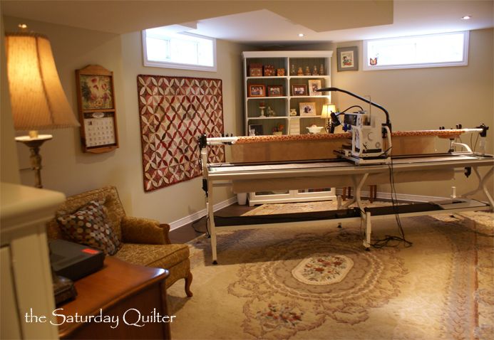 a living room filled with furniture and a baby crib next to a lamp on a table