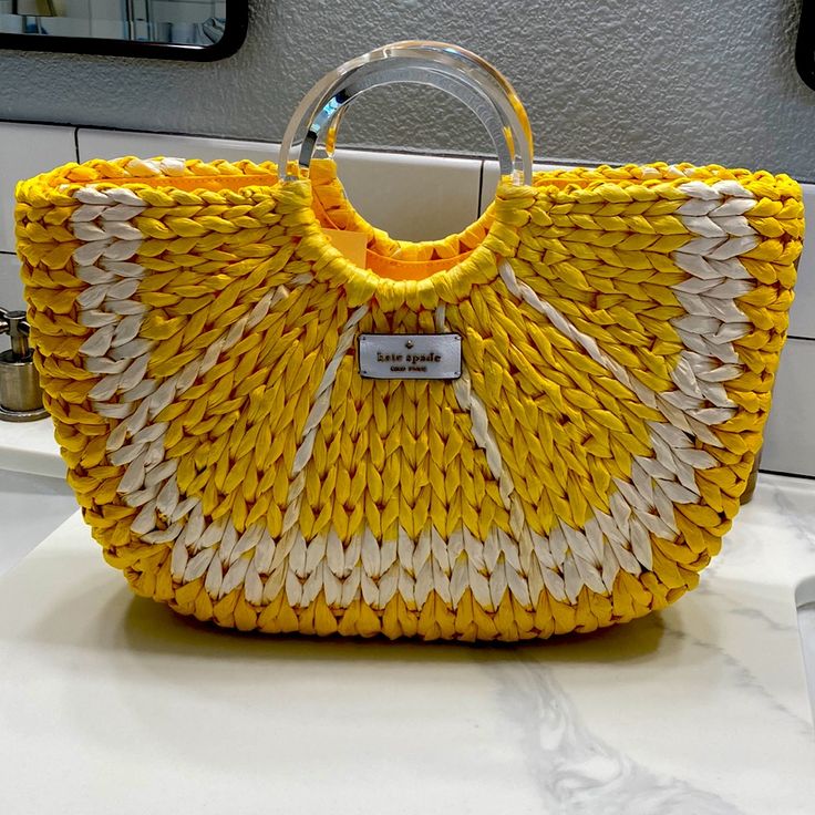 Beautiful Kate Spade Lemon Medium Tote. New With Tags Never Used. Original Price $399 Tote With Open Top Closure And Two Clear Plastic Circular Handles. Two Interior Zipper Pockets And Leather Patch Logo On Front. 12.59"W X 7.87"H X 3.3"D Dual Handle Drop: 4" Style: Wkru6835 Color: Yellow Multi (772) Yellow Tote Bags For Day Out, Yellow Tote Bag For Day Out, Chic Yellow Straw Bag For Everyday Use, Chic Yellow Woven Straw Bag, Yellow Rectangular Straw Bag For Spring, Chic Yellow Straw Bag For Everyday, Spring Rectangular Straw Bag In Yellow, Yellow Straw Bag With Braided Handles For Vacation, Chic Yellow Rectangular Straw Bag