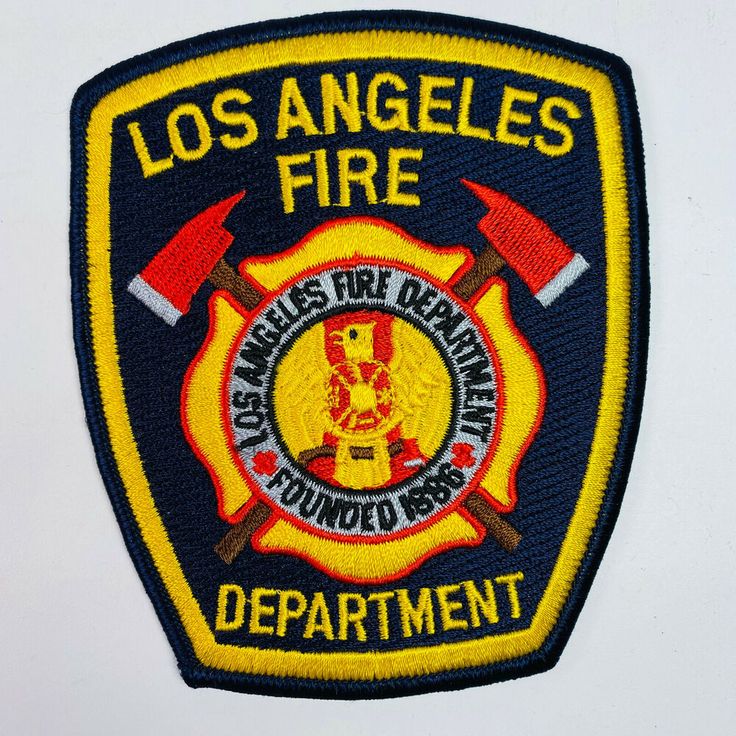 the los angeles fire department patch has two axes and an eagle on it's back