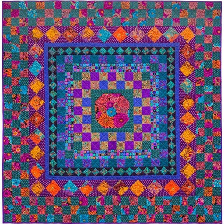 a colorful quilt with many different designs on it