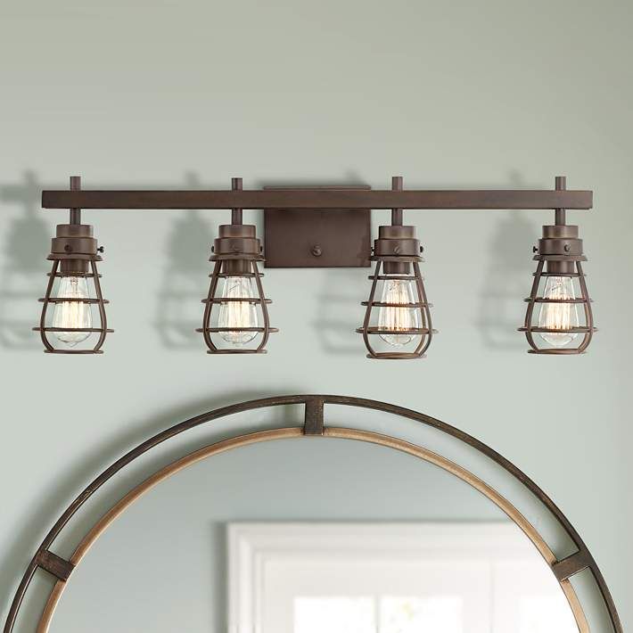 a bathroom light fixture with three lights on the ceiling and a mirror in front of it