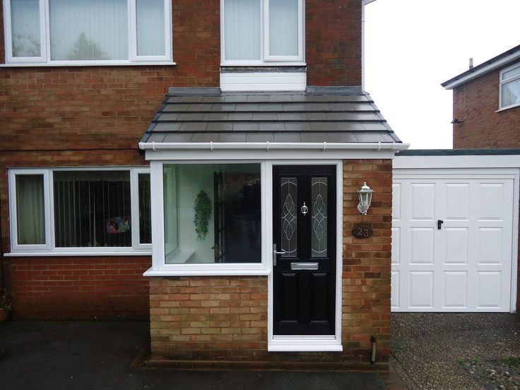 a brick house with white doors and windows