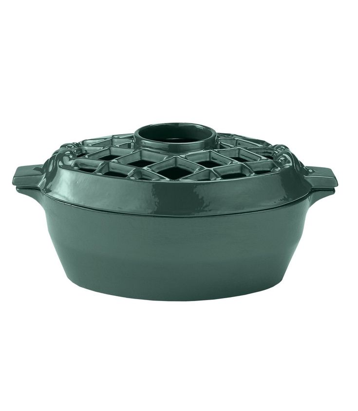 a green cast iron casserole on a white background