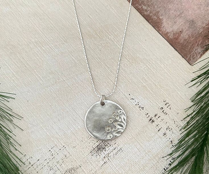 A beautiful Flower hand stamped Sterling silver charm on a dainty 24"Sterling silver chain. Perfect gift for flower lovers. Silver Stamped Necklaces As Gift For Mom, Dainty Stamped Silver Charm Necklace, Dainty Silver Stamped Charm Necklace, Silver Charm Necklace With Birth Flower Round Pendant, Silver Birth Flower Round Pendant Charm Necklace, Delicate Silver Charm Necklace For Mom, Delicate Silver Charm Necklace With Flower, Silver Hand Stamped Flower Pendant Jewelry, Silver Everyday Charm Necklaces With Flower Charm