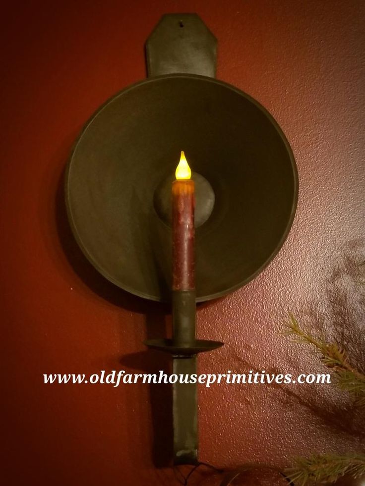 a candle that is lit on a wall