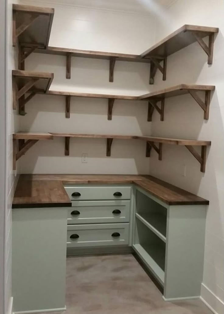 an empty walk in closet with shelves and drawers