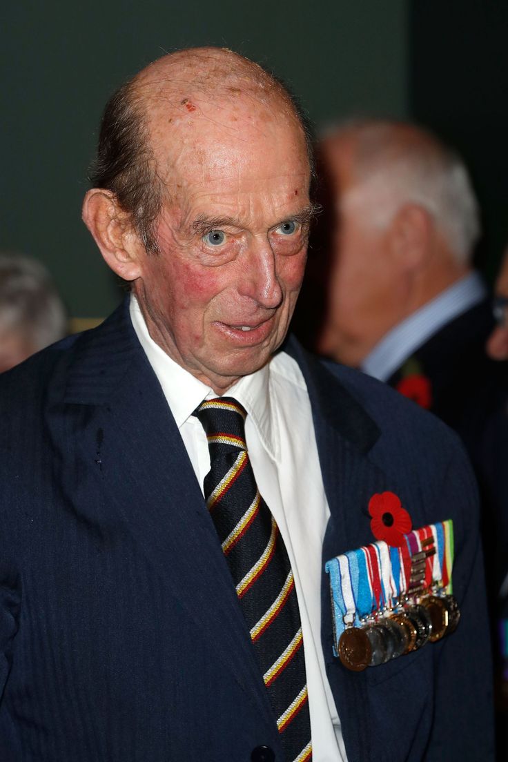 an older man in a suit with medals on his lapel