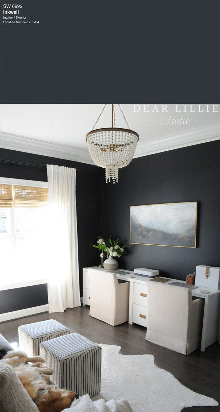 a living room filled with furniture and a chandelier hanging from the ceiling over a window