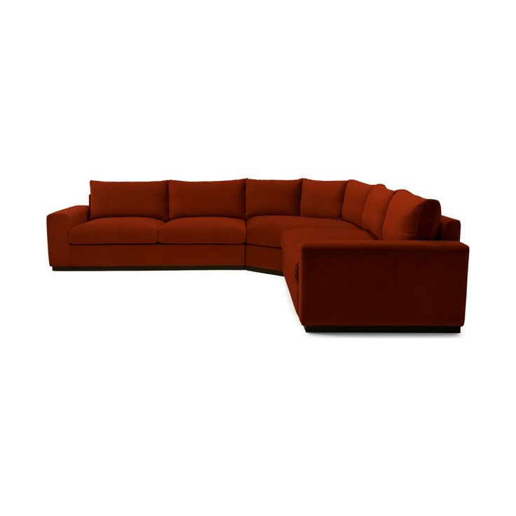 a large red couch sitting on top of a white floor