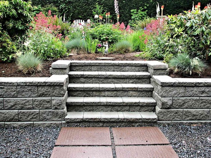 an outdoor garden with stone steps and flowers