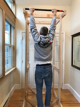 a man standing on a ladder in the middle of a room